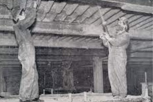 Two workers spraying Limpet spray insulation in an industrial setting